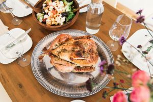 chicken dinner sitting on a silver plate