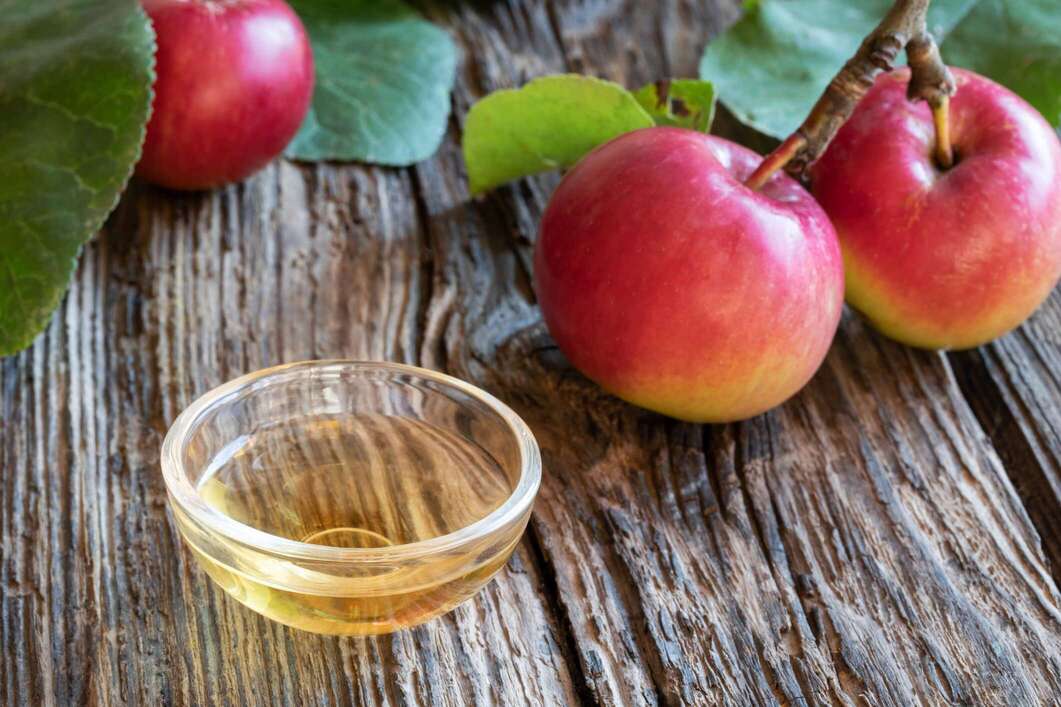 apple cider vinegar sitting on wooden table