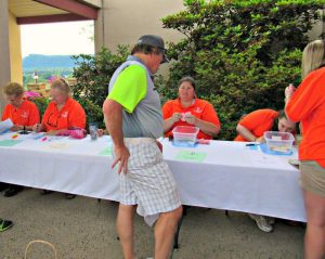 event organizers in orange polo shirts