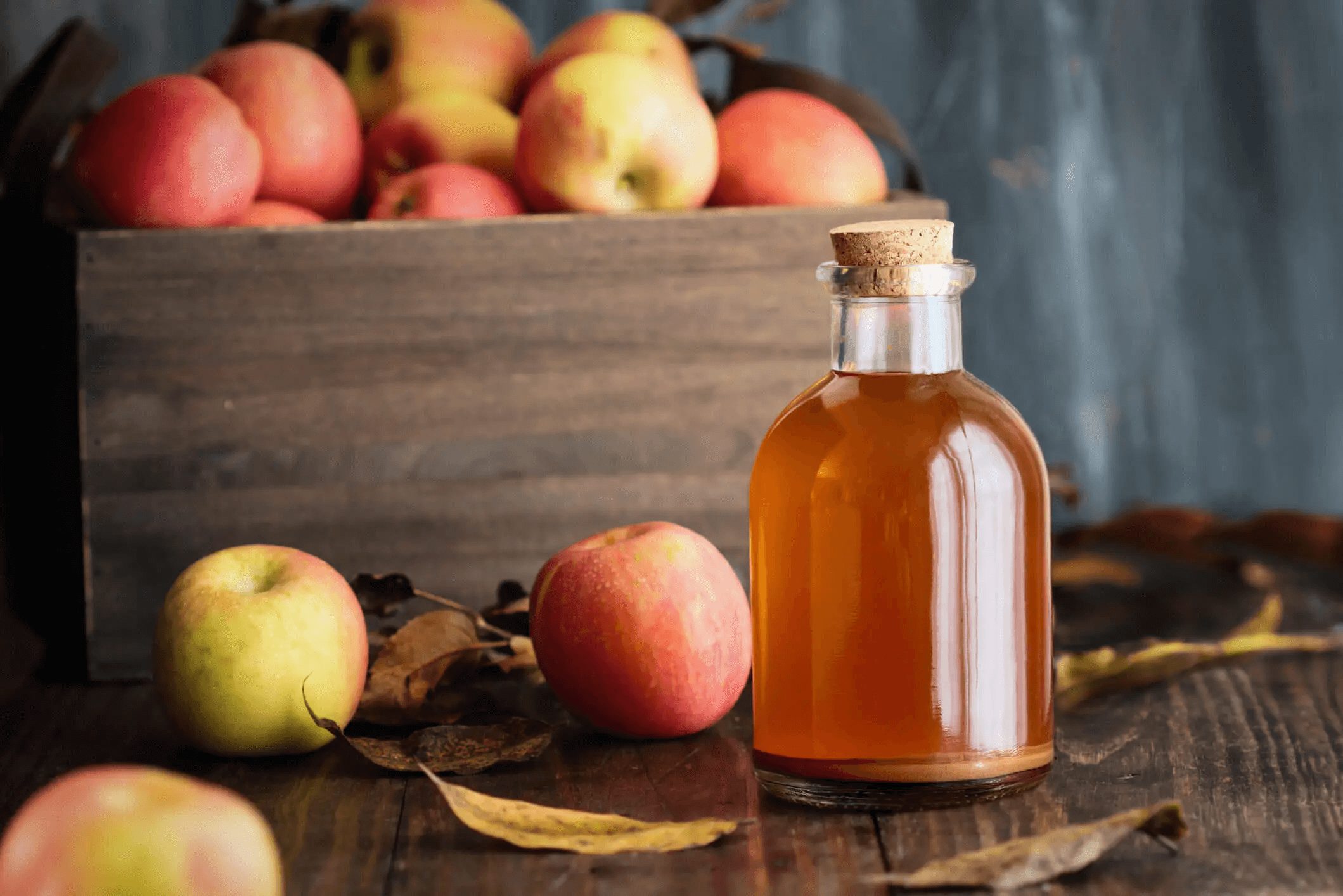 apple cider vinegar and crate of apples