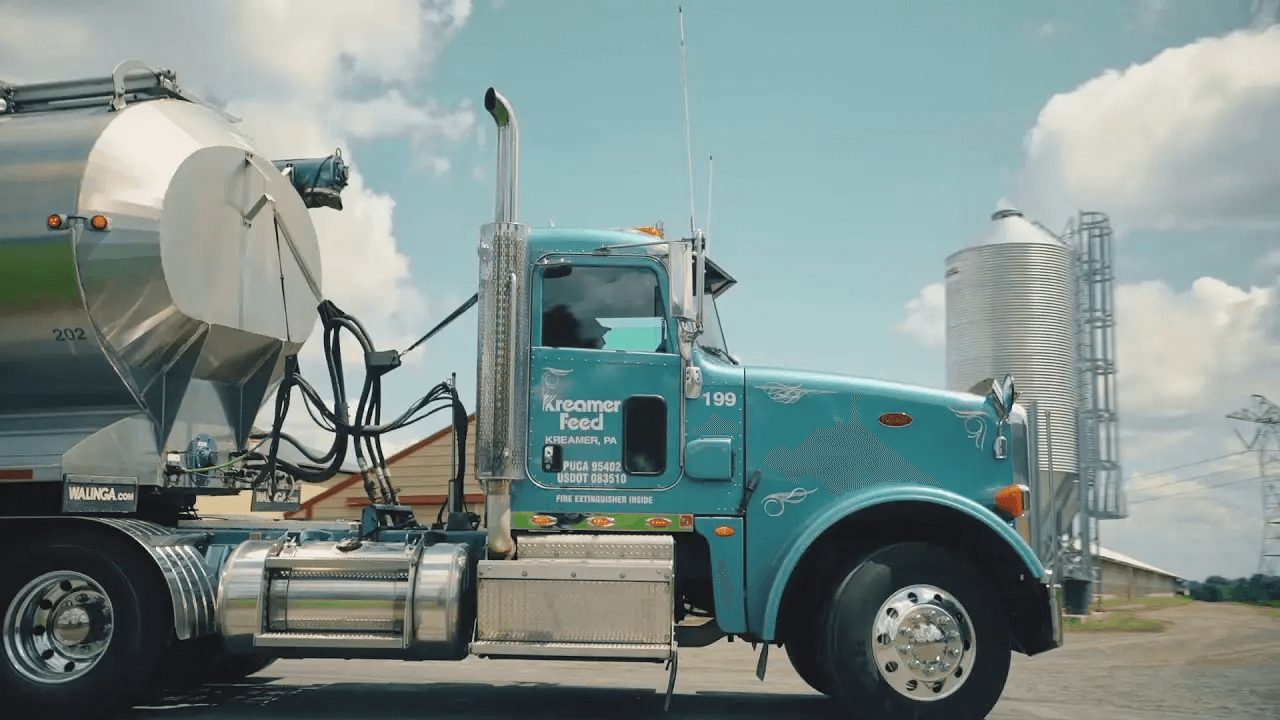 blue truck hauling organic animal feed